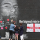 Local residents put messages of support on the plastic that covers offensive graffiti on the vandalized mural of Manchester United striker and England player Marcus Rashford.